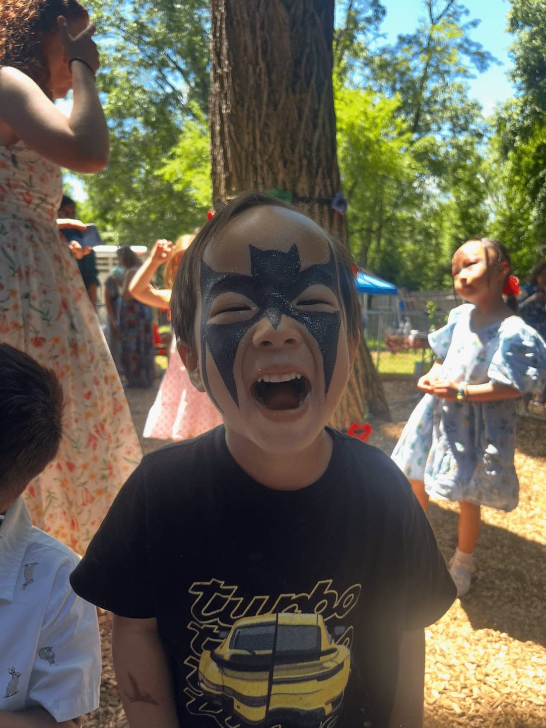 A joyful child with face paint at Beacon Montessori summer camp in Weston, MA